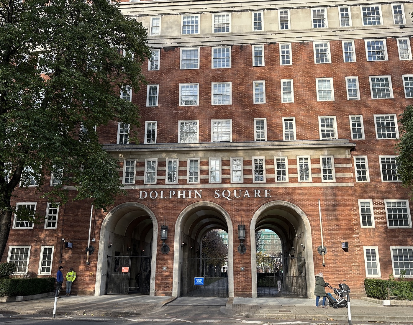 The brick facade and arched entrance of a large purpose-built block of flats