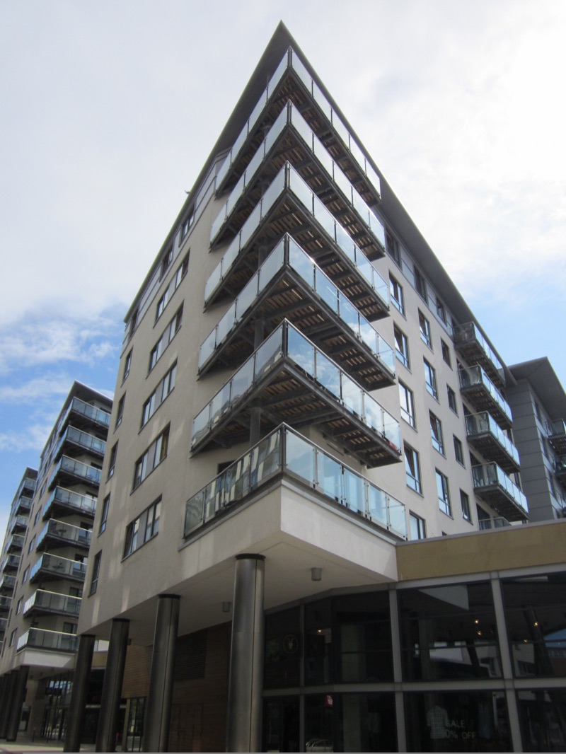 A modern apartment building with glass balconies in Leeds